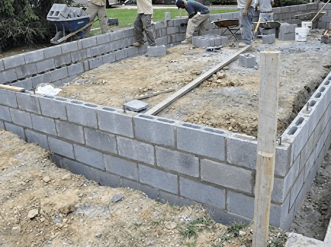 Professionals building a foundation with blocks in Des Moines, IA