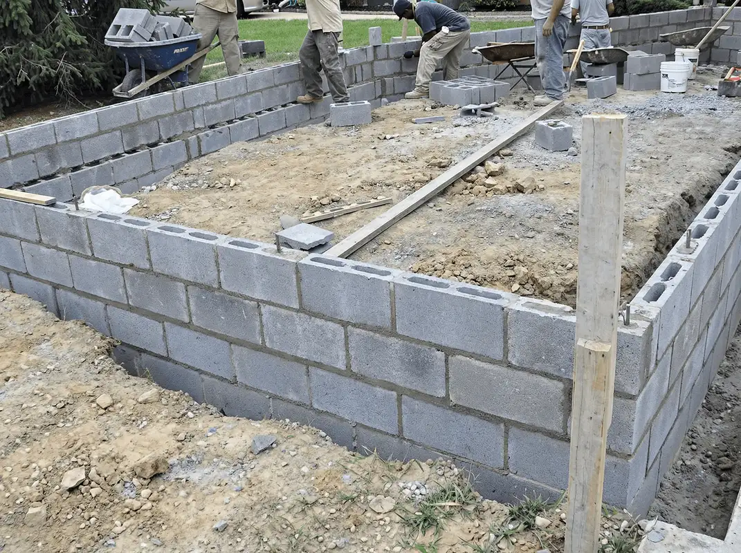 Professionals building a foundation with blocks in Des Moines, IA
