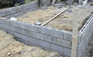 Professionals building a foundation with blocks in Des Moines, IA