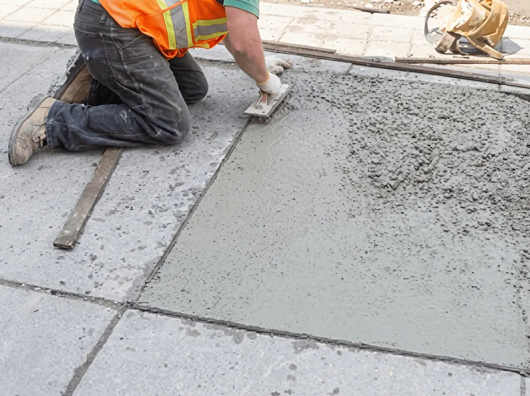 Professional repairing a concrete floor in Des Moines, IA