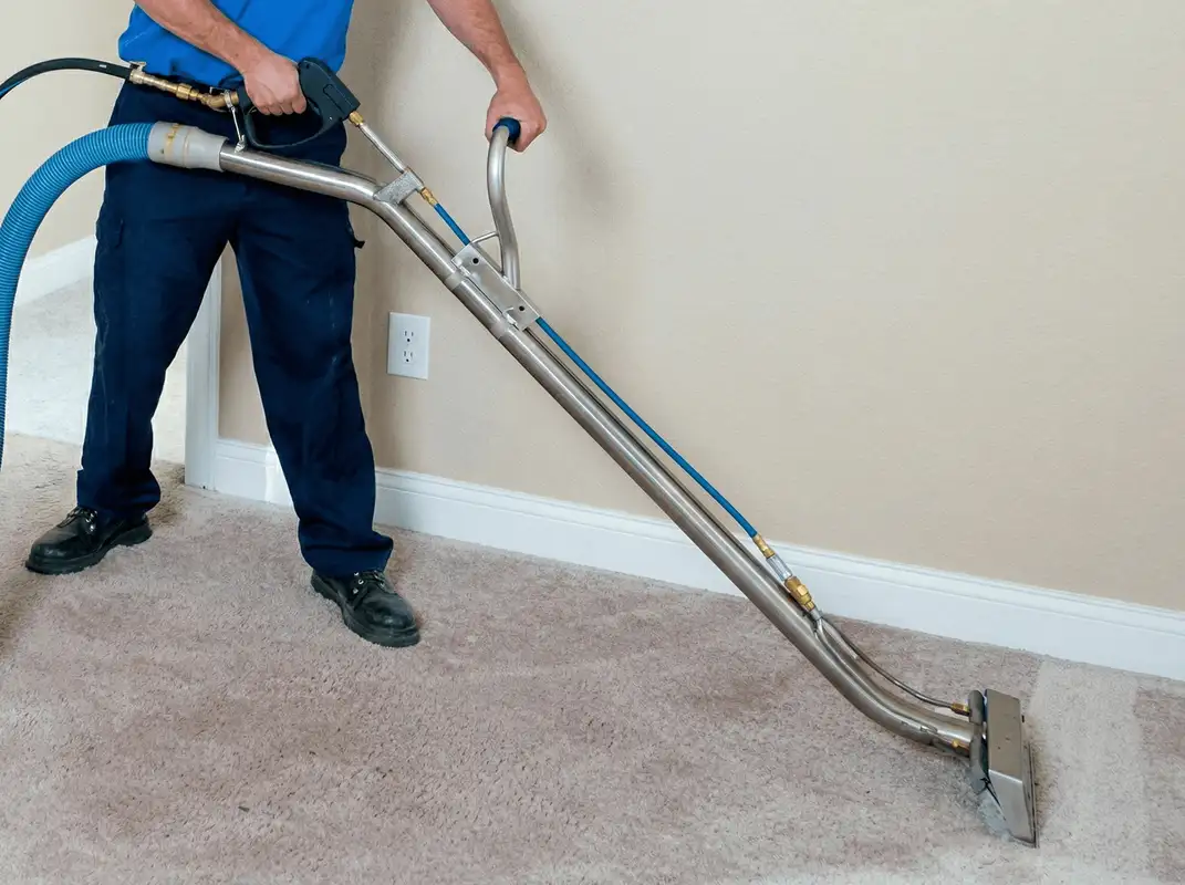 Professional operating a liquid removal machine on a carpeted floor in Des Moines, IA